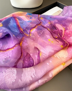 Close-up of gradient magnolia print silk scarf with jacquard texture and sheer fabric