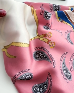Close-up of pink and blue paisley silk scarf showcasing smooth texture and elegant drape