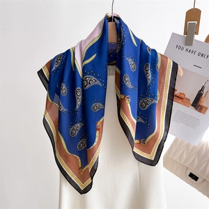 Navy blue square silk scarf with vintage paisley and belt buckle print on clothes hanger