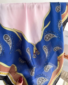 Close-up of lightweight silk scarf with paisley pattern and hanging chain print detail