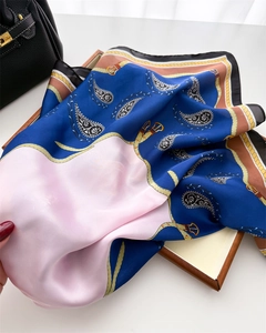 Close-up of silk scarf with paisley and equestrian chain patterns showing satin texture