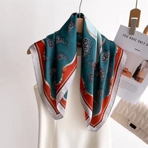 Elegant paisley and chain print silk scarf in deep teal and vibrant orange finish