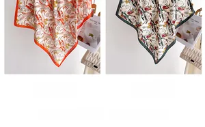 Detail of silk scarves with feather prints in orange and black with rolled edges