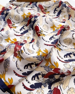 Detail of tropical plant leaf print on a white silky square scarf and shawl
