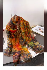 Close-up of floral print long silk scarf with vintage patterns and sheer texture