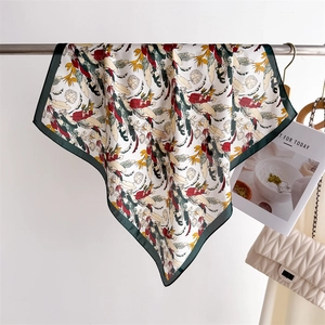 Detail of floral print silk scarf showing smooth texture and tropical leaf pattern