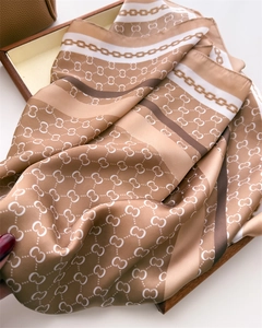 Detail of silk-feel square scarf with earthy plaid print and elegant chain patterns