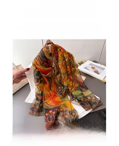 Detail of vintage floral pattern on a luxurious silk-like scarf draped on a white sweater