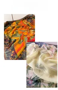 Detail of soft silk scarves featuring tropical prints and floral patterns on lightweight fabric