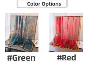 Detail of floral print scarves in green and red with orange edges and soft fabric