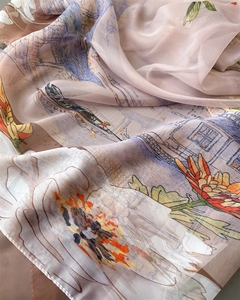 Close-up of translucent printed silk scarf with floral patterns and soft fabric texture