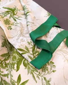 Detailed macro view of the silky fabric texture and olive green floral print with green edges