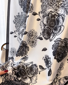 Detail of silk-like floral scarf fabric featuring elegant vintage black rose prints