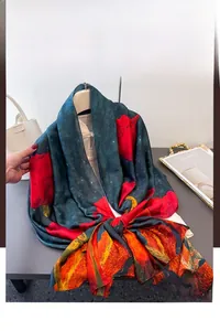 Detail of silk-like floral shawl with dark teal background and red rose patterns