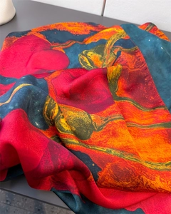 Macro detail of silky satin scarf fabric with vibrant floral print and glossy finish