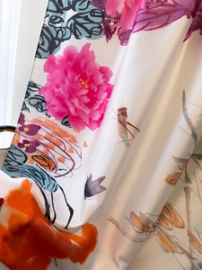 Detail of rose and butterfly floral print on smooth faux silk shawl fabric
