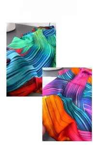 Detail of colorful linear wave print silk scarf with vibrant red green and blue patterns