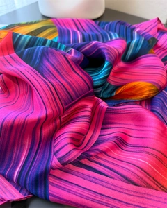 Macro detail of silk scarf showing flowing abstract colorful stripes and smooth texture