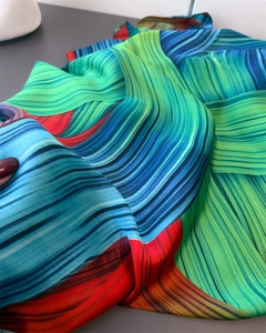 Detail of silk-satin scarf showing vibrant wavy stripes and smooth glossy texture