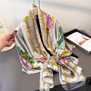 Floral faux silk scarf with green and purple flower patterns and golden border