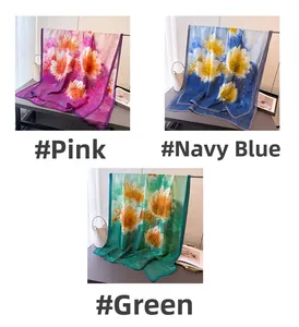 Floral print satin scarves displayed in pink, navy blue, and green with elegant drape