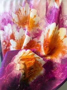 Detailed texture of purple floral silk scarf with orange flower digital print and smooth finish