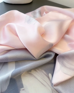 Detail of thin faux silk shawl featuring peony prints and smooth satin texture