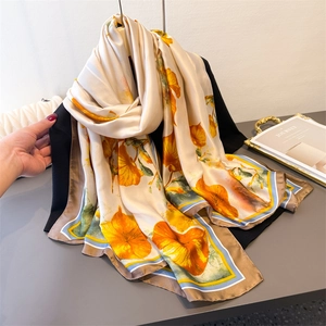 Lightweight cream floral silk scarf with vibrant orange flowers and striped borders