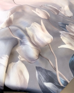 Detailed close-up of premium silk scarf showing elegant tulip prints and soft drape