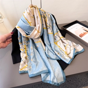 Sky blue silk scarf with white floral and gold bamboo patterns for summer sun protection
