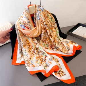 Elegant orange floral silk scarf with vintage oil painting pattern draped on black apparel