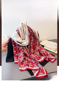 Detail of red floral printed silk scarf with double-sided contrast design and soft texture