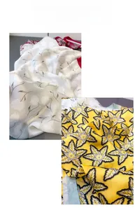 Detailed close-up of floral print silk scarves featuring grey leaves and yellow maple patterns