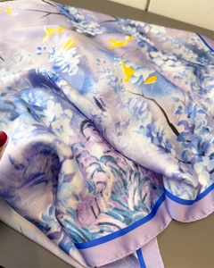 Close-up of purple satin scarf featuring blue floral prints and yellow bird details