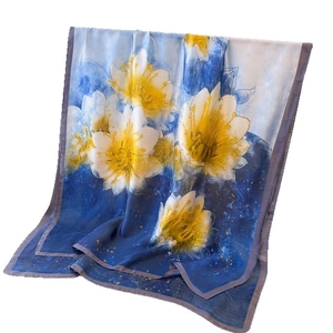 Artistic silk scarf with white water lily prints on a deep blue and white background