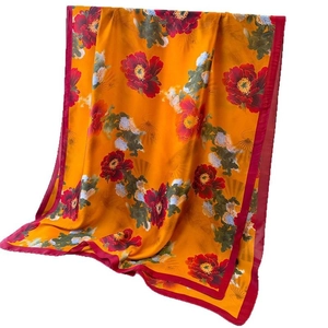 Silk-like satin long scarf with elegant peony floral print and vibrant orange golden base
