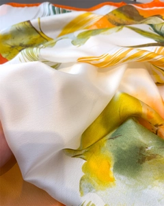 Close-up of lightweight faux silk scarf showing smooth satin texture and floral print