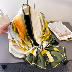 Elegant sunflower print silk scarf in olive green and yellow with lightweight floral design