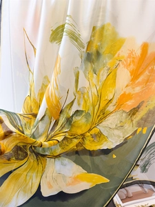 Close-up of silky satin scarf with floral prints showing smooth texture and soft drape