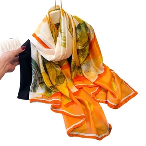 Floral print satin long scarf in vibrant orange and yellow tones for sun protection
