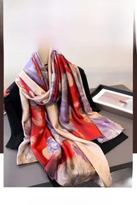 Detail of silk scarf showing red and purple floral patterns and glossy texture