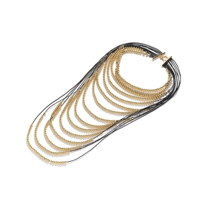 Multilayer beaded necklace featuring black cords and gold beads with a toggle clasp closure