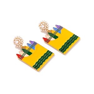 Detail of colorful crayon earrings with gold plating and white pearl studs on white background