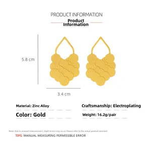 Detail view of layered gold leaf earrings with textured discs and size dimensions