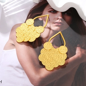 Layered gold leaf earrings with textured hammered discs and large water drop hooks