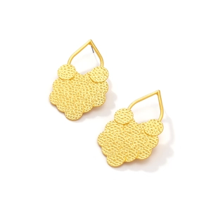 Detail of gold layered leaf earrings featuring hammered metal texture and teardrop hooks