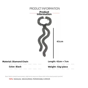 Macro detail of wave-shaped black rhinestone multilayer tie necklace with chain specs