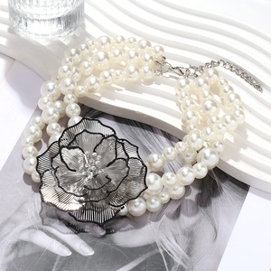 Collier de perles à trois rangs avec pendentif grande fleur en métal ajouré et strass
