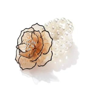 Bohemian multilayer pearl bracelet featuring a handcrafted gold floral charm with crystals