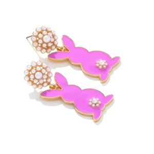 Close-up of pink enamel rabbit earrings with white pearl flower studs and gold accents